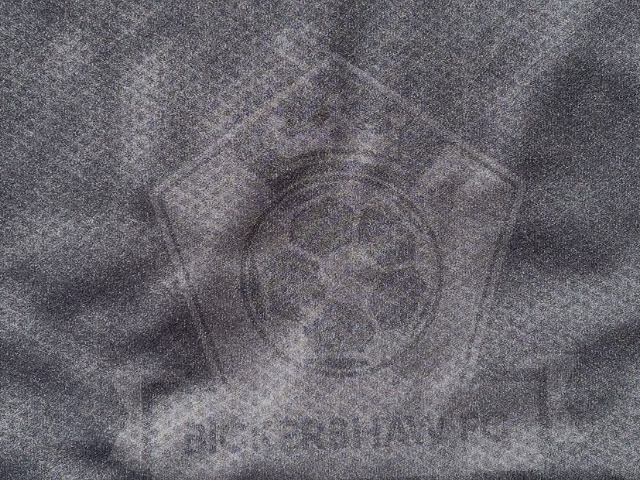 Tonal black-on-black 22 Unite crest printed on fabric