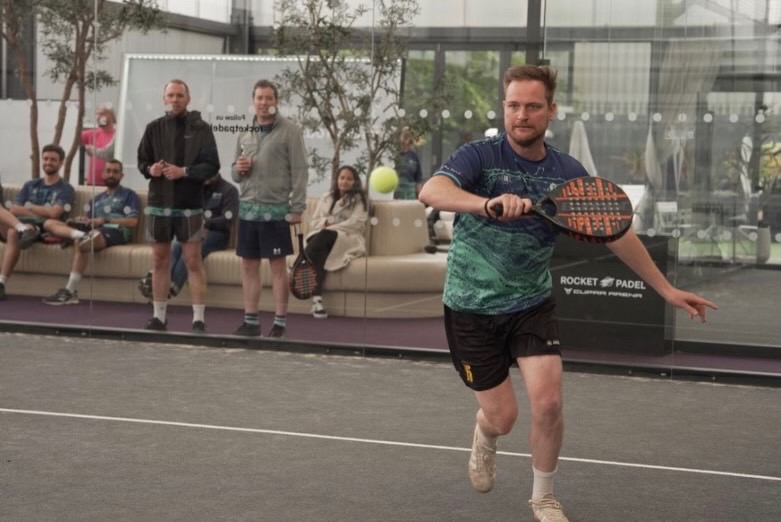 Padel player in action wearing a 22 Unite shirt