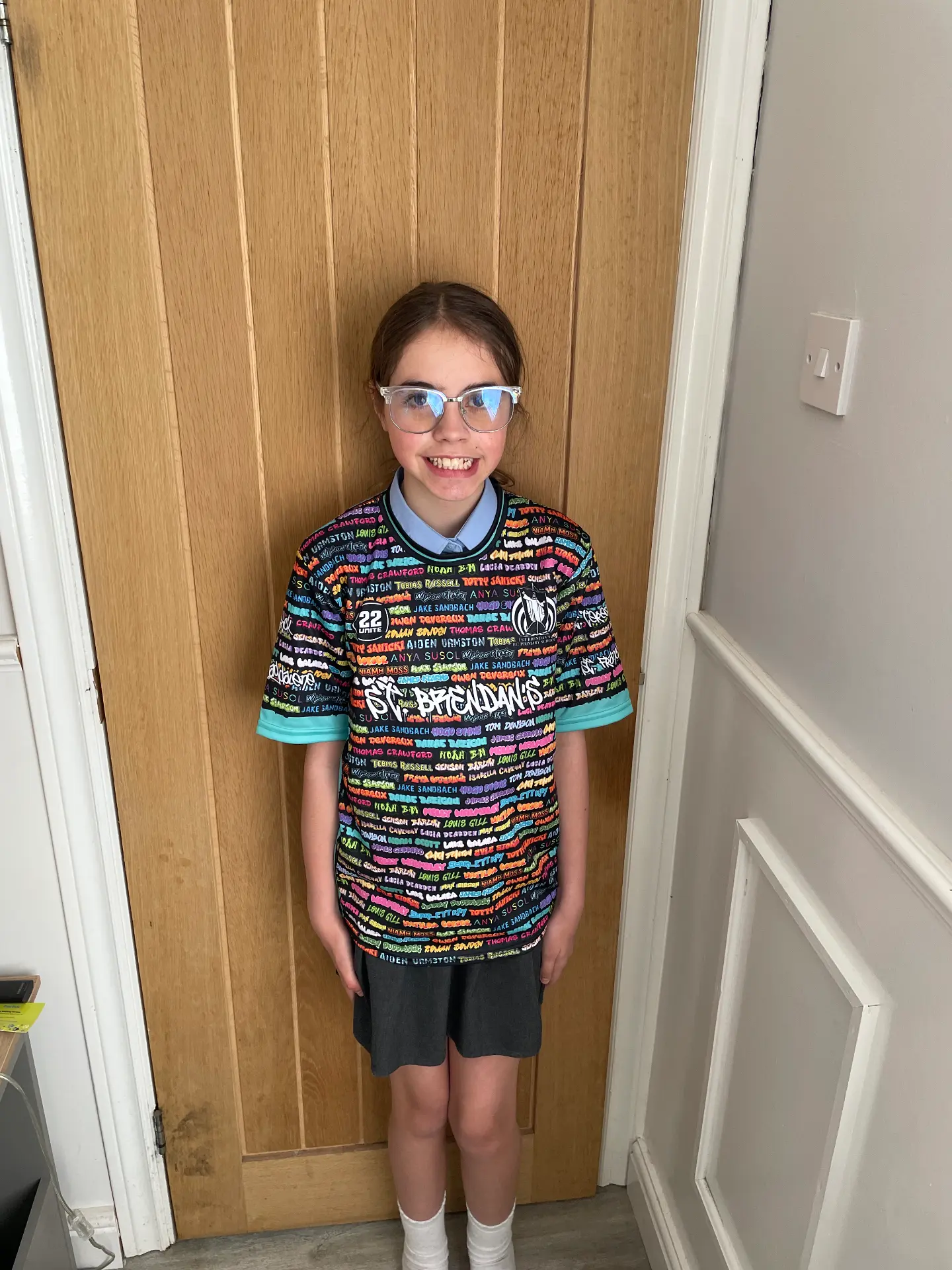Pupil wearing a black 22 Unite shirt printed with colourful names