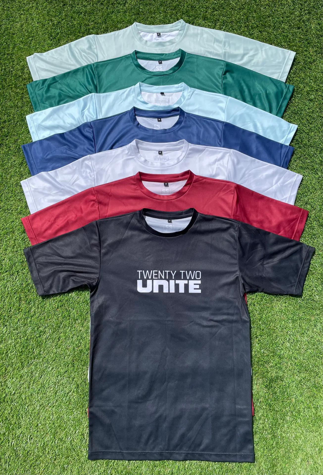 Stack of coloured 22 Unite training T-shirts