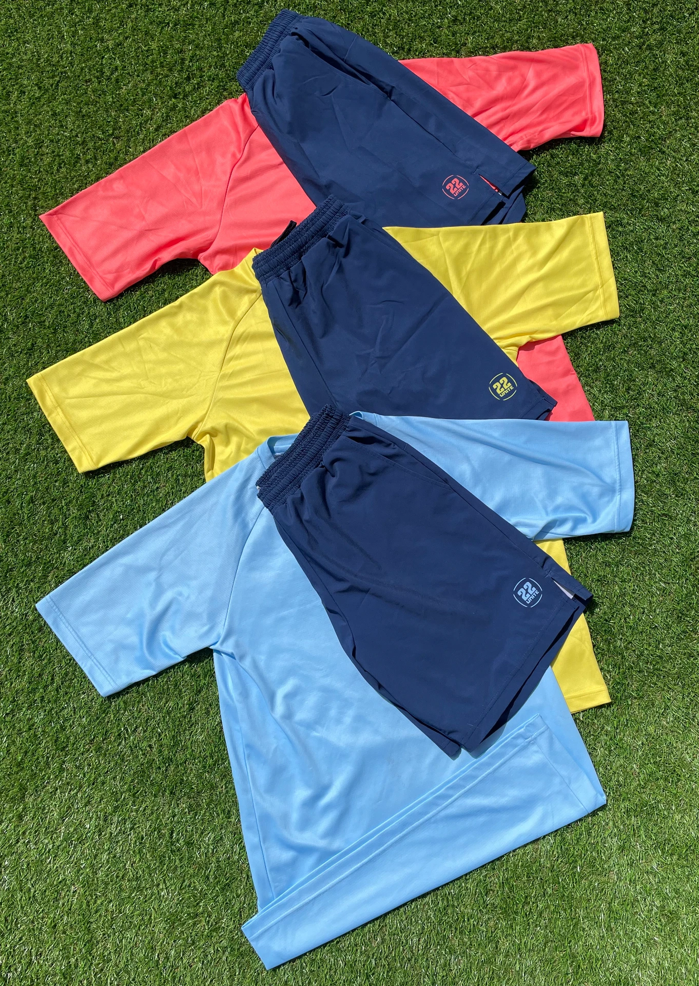 Coral, yellow and sky blue 22 Unite training shirts with navy shorts
