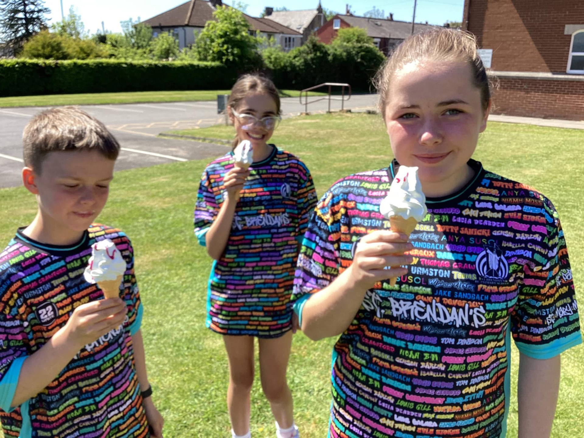 Pupils in black 22 Unite shirts holding ice cream cones