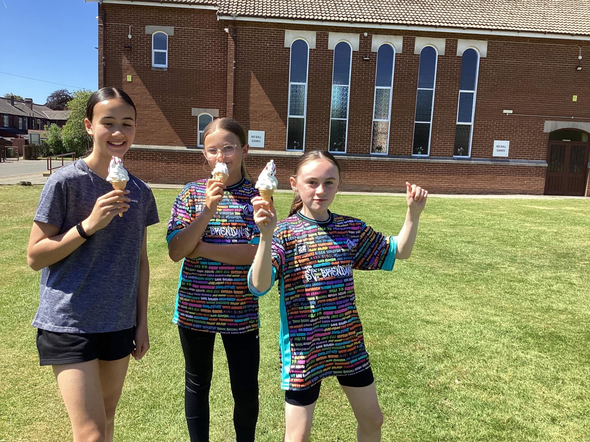 Pupils in 22 Unite sports shirts outside a school